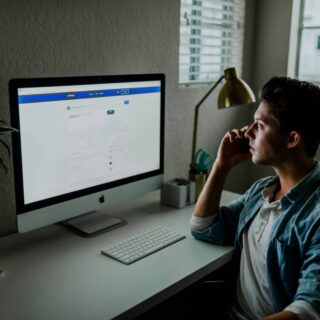 man working at desk by lamp