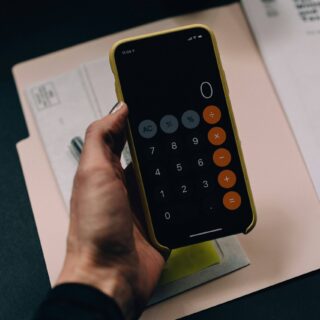 hand holding a calculator